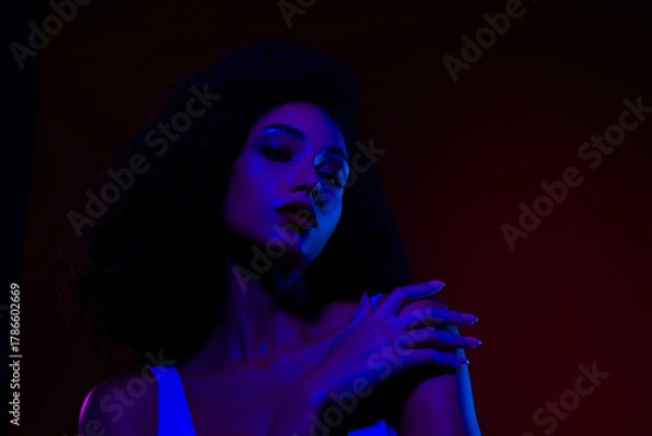 Fototapeta Portrait of a Young Woman in Neon Lighting Highlighting Glamour and Modern Fashion Style