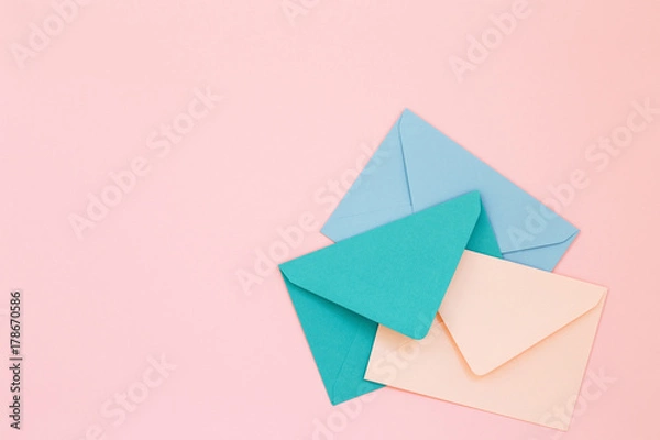 Obraz Three colored envelopes on pink background. Minimalist styled composition, top view, correspondence concept.