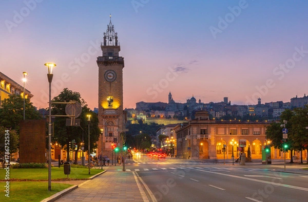 Fototapeta View of Torre dei Caduti and Bergamo skyline at dusk in Lombardy, Italy