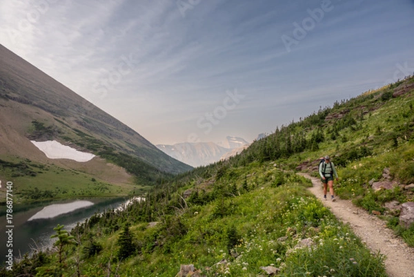 Fototapeta Backpacker Passing Ptarmigan Lake In Glacier