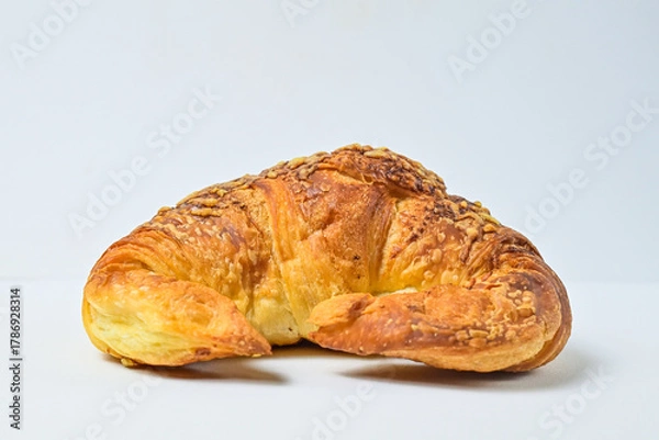 Fototapeta Side view of cheese croissant isolated on white background. Clipping path. Fresh, brown. close up.