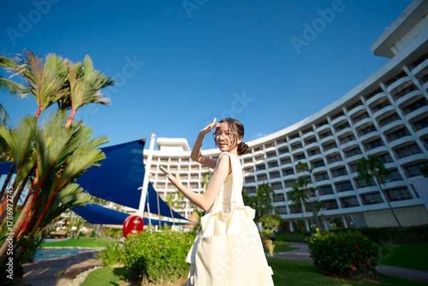 Obraz Young woman enjoying travel vacation at penang hotel resort