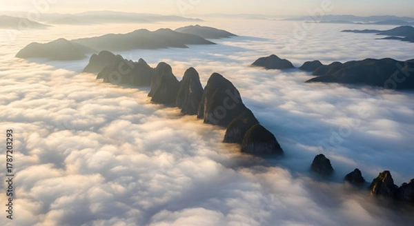 Fototapeta Aerial Tranquil Mountain Range Emerging from Sea of Clouds Landscape