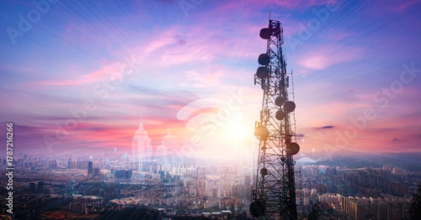 Obraz Telecommunication tower with cityscape background at sunset,panoramic view