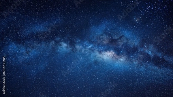 Fototapeta Panoramic blue night sky with the Milky Way, stars and nebula across a dark horizon