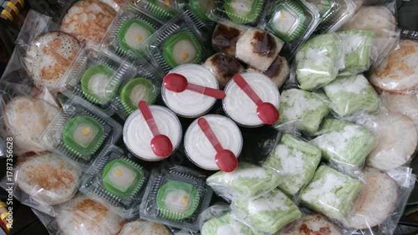 Fototapeta Jajan pasar (market snacks) in Java, consisting of assorted kue. Jajan Pasar is Indonesian traditional sweet and savory snacks usually sold in traditional market, street and village