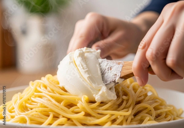 Fototapeta Creamy pasta perfection with this simple Food Hacks trick. A Quick Recipe for adding soft cheese to spaghetti for a delicious meal