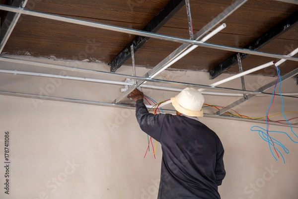Obraz Electricians are wiring the building.