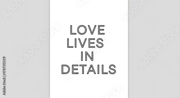 Fototapeta A minimalist design featuring the phrase 'Love Lives in Details' written in bold, black capital letters on a white background with subtle gray borders on each side