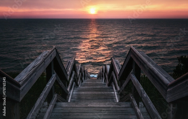 Fototapeta Surreal Sunset Stairway to the Sea. Low Key Vintage Style with Copy Space.