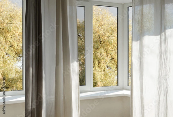 Fototapeta  View from the window  on yellow treesin a garden, landscape with autumn forest, window frame.