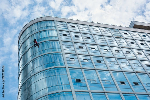 Fototapeta Curved Glass Facade with Window Cleaner - Urban Rope Access Scene