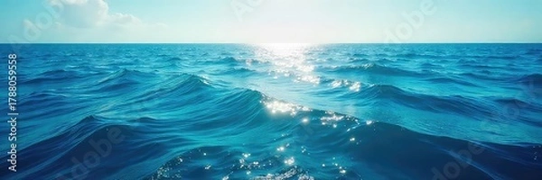 Fototapeta Vast expanse of deep blue ocean water, sunlit surface reflecting the sky, gentle waves rolling in Tranquil seascape, perfect for travel or nature themes , sunlight, bright