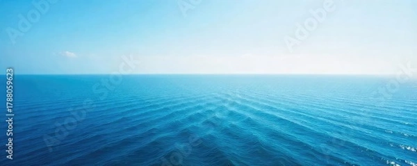 Fototapeta Vast, tranquil ocean stretching to the hazy horizon, a serene seascape perfect for travel or nature themes The endless blue meets the sky in a breathtaking panorama , landscape, serene, sky blue