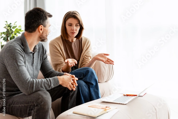 Fototapeta Couple having therapy session discussing problems with counselor
