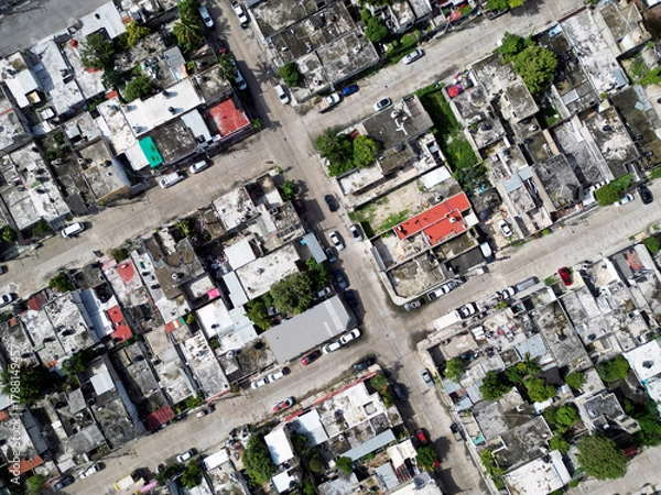 Fototapeta Aerial top-down view high altitude of slum a heavily populated urban informal settlement characterized by substandard housing and squalor poor living conditions streets and rusty metal home roof tops