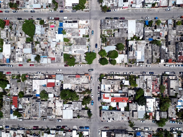Fototapeta Aerial top-down view high altitude of slum a heavily populated urban informal settlement characterized by substandard housing and squalor poor living conditions streets and rusty metal home roof tops