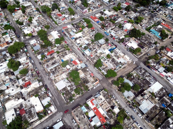 Fototapeta Aerial top-down view high altitude of slum a heavily populated urban informal settlement characterized by substandard housing and squalor poor living conditions streets and rusty metal home roof tops
