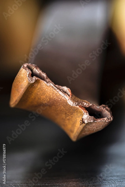 Fototapeta Oxidized broken copper profile, non-ferrous metal scrap, close-up of copper structure with industrial soft background