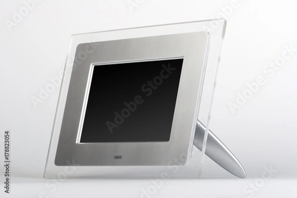 Fototapeta Digital frame with black screen. Transparent glass and silver frame on white background