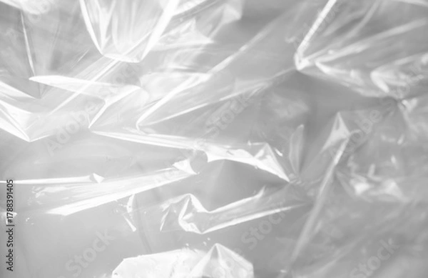 Obraz Abstract close-up of a crinkled transparent plastic surface in black and white tones with soft lighting and shadows.