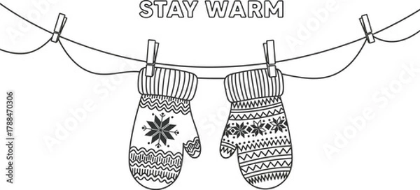 Fototapeta Two winter mittens hanging on a clothesline with the words stay warm above them