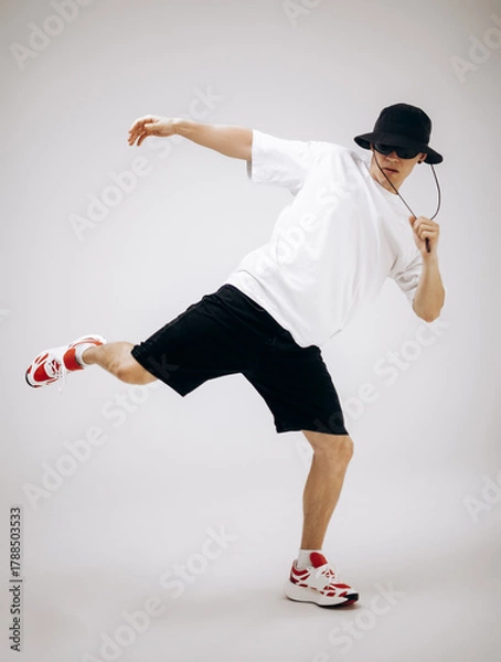 Obraz Young hip-hop dancer in street style summer outfit isolated on light background