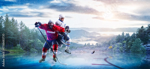 Obraz Hockey players in action on the ice. Outdoor game. Sports. Hockey match. A large hockey rink in the middle of an forest. Hockey concept. Panorama