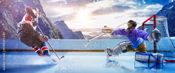 Obraz Hockey players in action on the ice. Outdoor game. Sports. Hockey match. A large hockey rink in the middle of an forest. Hockey concept. Panorama