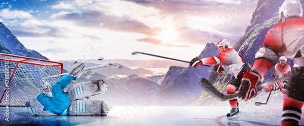 Obraz Hockey players in action on the ice. Outdoor game. Sports. Hockey match. A large hockey rink in the middle of an forest. Hockey concept. Panorama