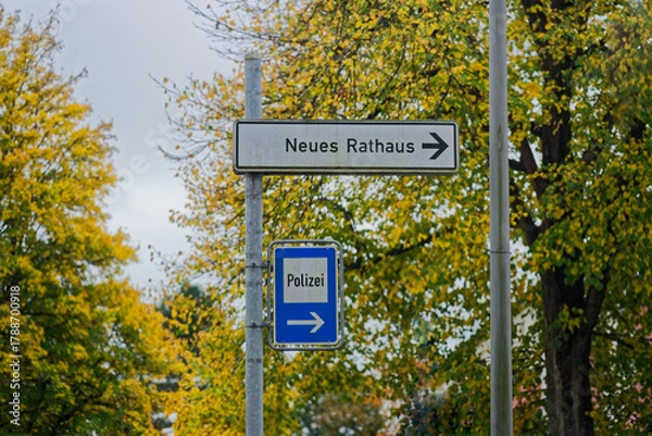 Obraz Direction sign to police and new town hall with arrows right in german language