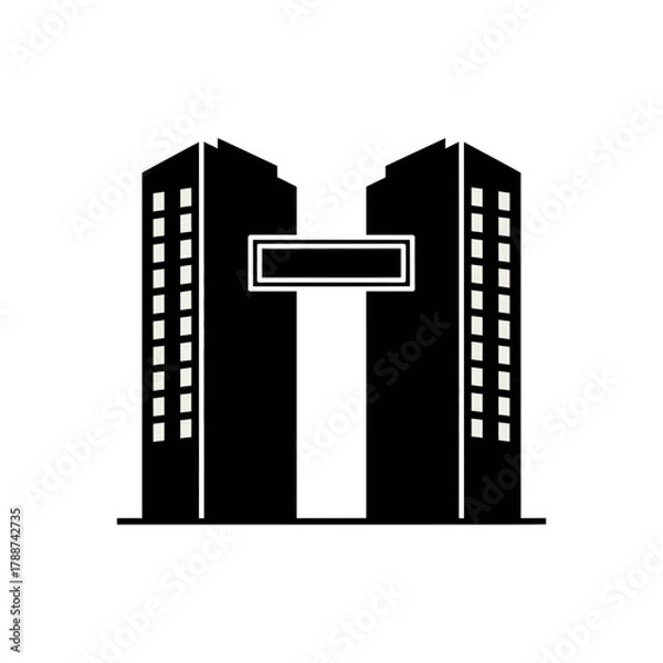 Obraz Two buildings connected by a sign form a letter T shape.