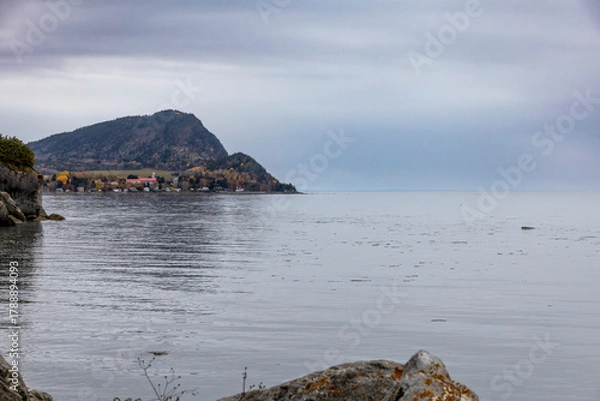 Fototapeta Tranquil view of the St. Lawrence River near Riviere du Loup, Quebec, capturing serene waters and a majestic mountain backdrop.