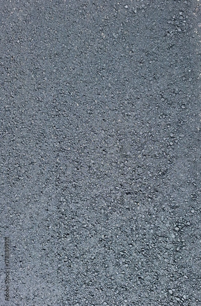 Fototapeta Texture of fresh asphalt showing fine grains and smooth surface under natural light in a pavement construction area