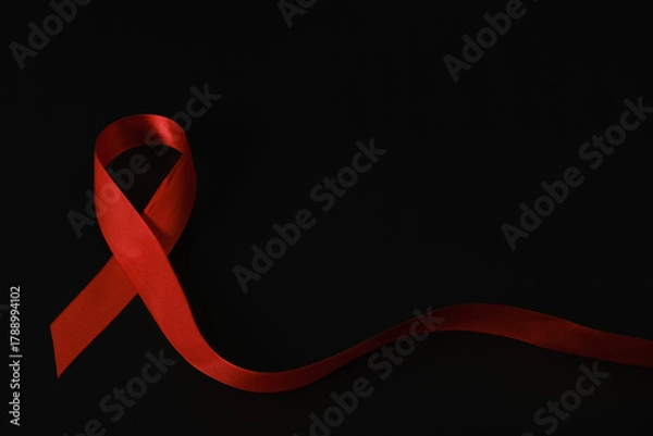 Fototapeta red ribbon symbol of World AIDS Day. Top view. Free copy space.