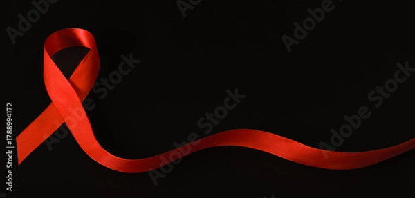 Fototapeta red ribbon symbol of World AIDS Day. Top view. Free copy space.