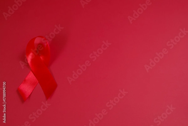 Fototapeta red ribbon symbol of World AIDS Day. Top view. Free copy space.