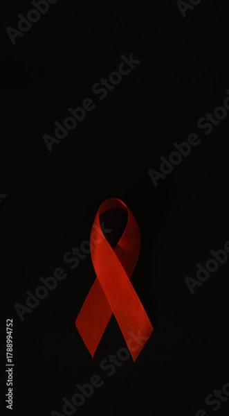 Fototapeta red ribbon symbol of World AIDS Day. Top view. Free copy space.