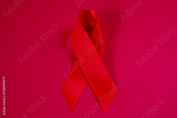 Fototapeta red ribbon symbol of World AIDS Day. Top view. Free copy space.