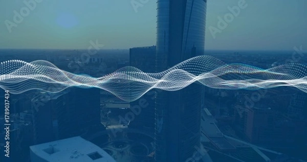 Obraz Highlighting reflective cylindrical skyscraper rising over downtown plaza, showing waveform overlay