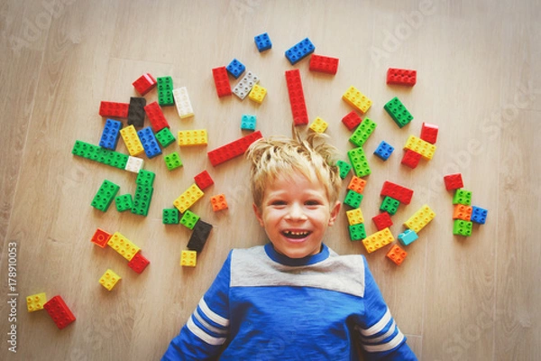 Fototapeta happy little boy love playing with plastic blocks