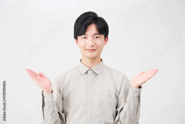 Obraz 手のひらで左右を指す男性　20代　白背景