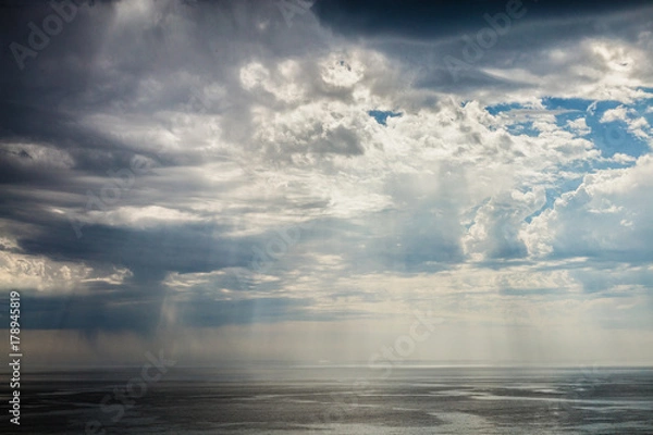 Obraz Sun Rays Through Thunder Clouds.