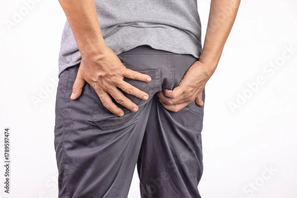 Obraz Hemorrhoidal pain, man with hemorrhoids on white background.