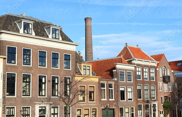 Fototapeta Oude Vest Building Facades with Power Station Chimney in the Background in Leiden, Netherlands