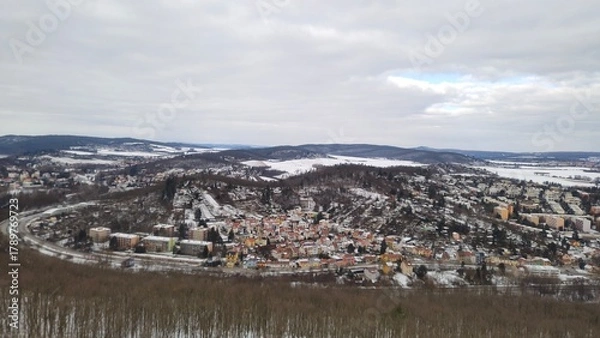 Obraz Charming panoramic view of a snow covered village surrounded by trees and fields near Brno, Czech Republic.