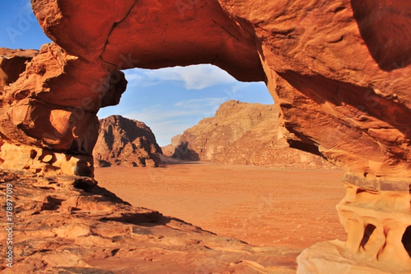 Obraz Wadi Rum red dessert in Jordan.The view of rock formations by natural rock window.