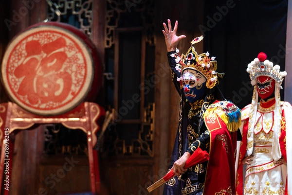 Fototapeta Chinese actor performs a public traditional changing face performance onstage in Chengdu, China