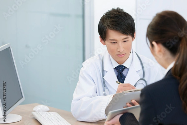 Obraz 打ち合わせをする医師とビジネスウーマン 