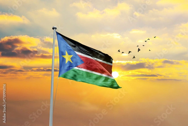 Obraz South Sudan flag waving in sunset or sunrise. South Sudan flag for Republic Day and Independence Day.